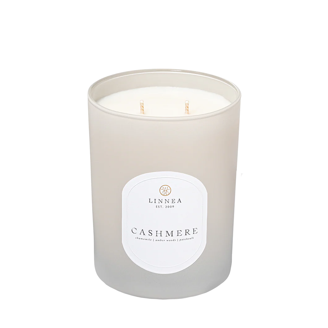 Frosted candle with 'LINNEA' label on a white background