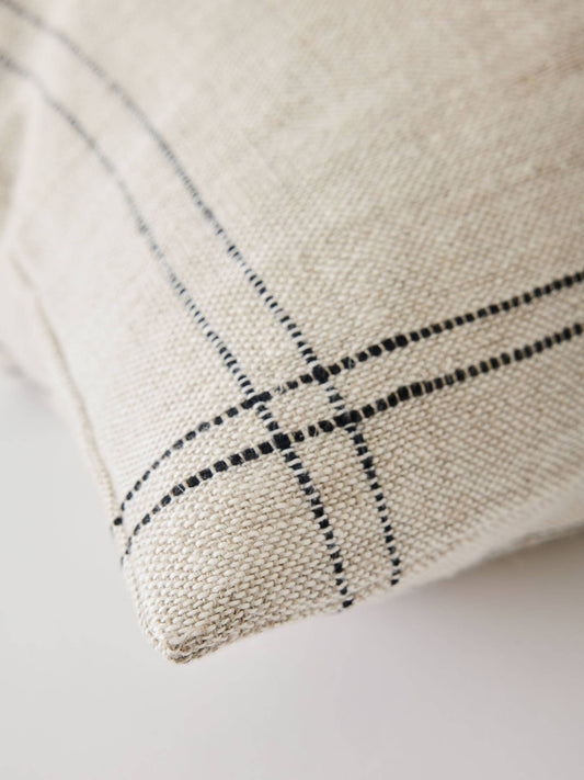 Close-up of a textured fabric with black line pattern on a light background
